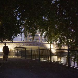 Hämeensilta bridge, lightened in darkness, huoman being in left side of picture..