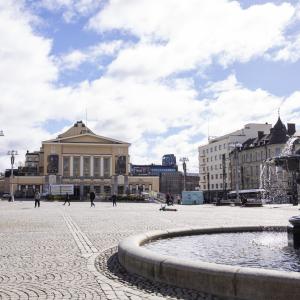 Tampere Central Market is a large and open space for pedestrians, with a fountain in the foreground and the Tampere Theatre and Old Church in the background.