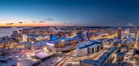 An atmospheric aerial view of Tampere city centre in the evening light. Nokia Arena in the foreground.