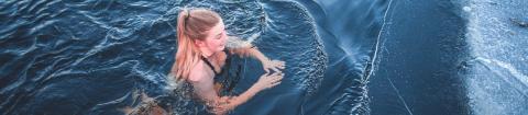 A girl swimming in ice-cold water.