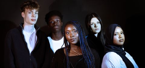 Five young people in a group photo.