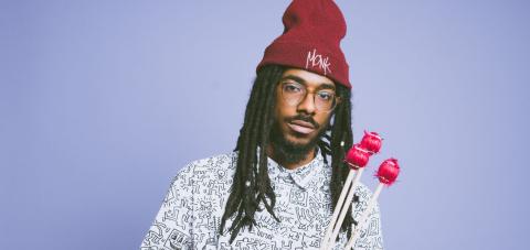 Joel Ross, vibraphone mallets in hand and a Monk beanie on his head.