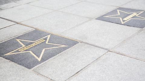 Two stars with names embedded in the street.