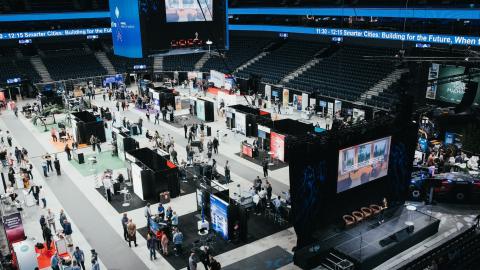 Nokia Arena exhibition area from above, visitors walking around.
