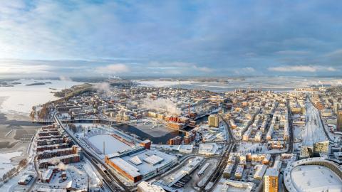 Dronella otettu maisemakuva, jossa etualalla luminen Nokia Arena ja Ratina, keskellä Tammerkoskea ympäröivät tiilitalot ja taustalla Näsijärvi.