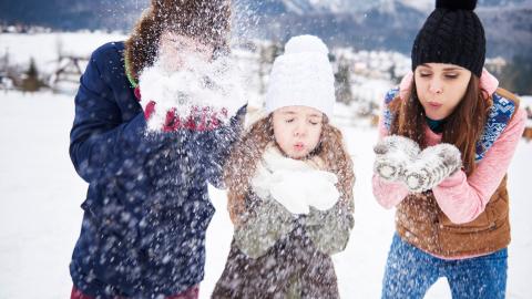 A family playing in the snow.