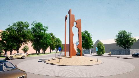 Kuva liikenneympyrästä, jonka keskellä nousee neljä silhuettimaista pylvästä.