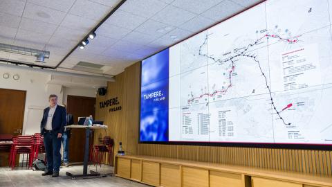 The person on the left of the picture is showing the tram plans on a large screen.