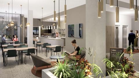 Havainnekuva kahvilan pöydistä ja etualalla olevasta kasvialtaasta, joka kiertää pylvästä.