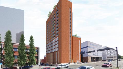 The image shows a city environment and a redbrick high-rise building that includes a lower section.