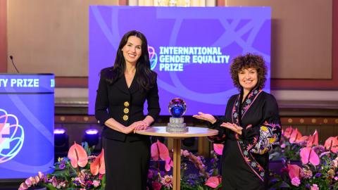 Mariia Yefrosinina, left, and Oksana Nechyporenko, right, founders of the Masha Foundation. They are surrounded by beautiful floral arrangements and a stone and glass award on the table.
