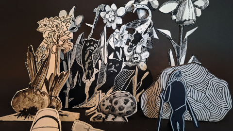 A drawing installation with figures and flowers.