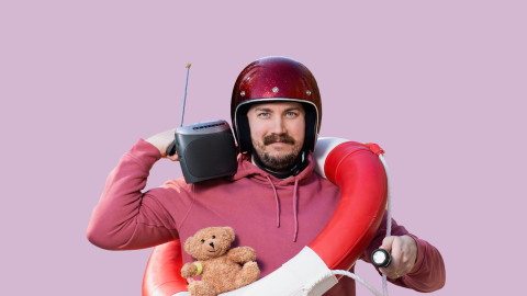 A bearded man with a helmet on, a radio on his shoulder and a life ring around his neck.