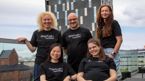 Elina Wallin (left), Ville Brusi, Mia Häkkinen, Shanshan Du, and Tredun's Abigeil Varuhin pose as a group on the rooftop terrace of Startup.Tampere.