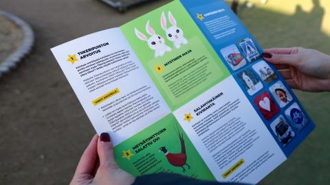 A photo of an adventure map for families with children, held by an adult. 