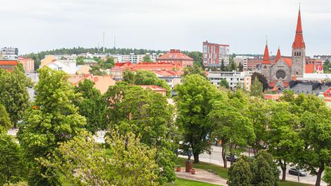 An aerial view of Tampere city centre, showing a summery park and the Cathedral