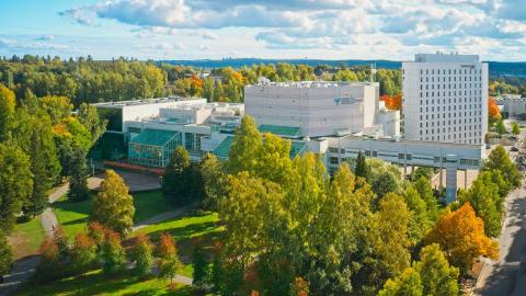 Tampere Hall set against an autumnal landscape.