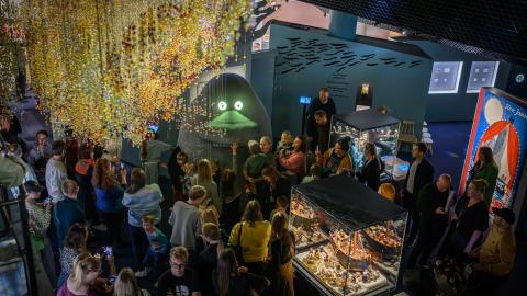 People have gathered around the Groke at the Moomin Museum. 