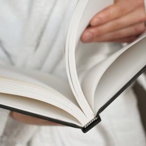 The person is holding an open book.