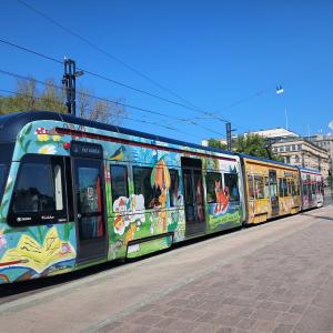 The tram covered in reading theamed artwork. 