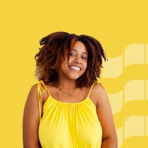 A smiling woman on an yellow background.