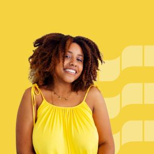 A smiling woman on an yellow background.