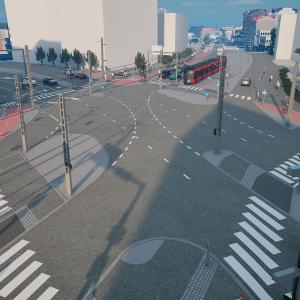 Kuvassa liikennevalo-ohjattu risteys, raitiovaunu, autoja ja muita kulkijoita.