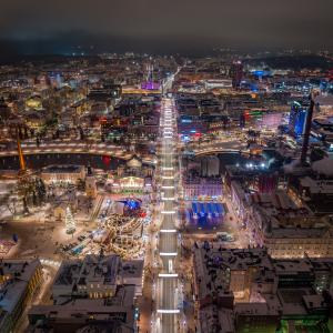 Aerial view of Tampere city centre on a winter night. The lights are shining brightly.