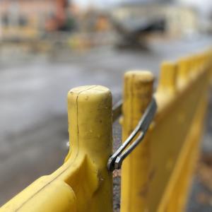 Keltaista katutyömaa-aitaa työmaan reunalla.