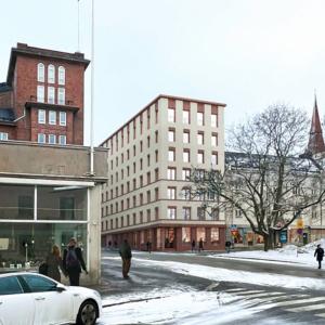 Kuvassa vanhaa kaupunkirakennetta ja uusi talo.