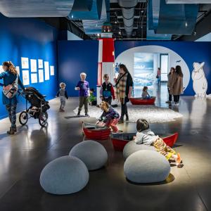 Visitors to the art exhibition are viewing the Moomin artworks. 