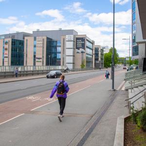 A woman walks along Sorinsilta in the sunny spring weather.