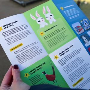 A photo of an adventure map for families with children, held by an adult. 