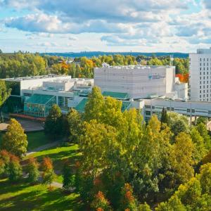 Tampere Hall set against an autumnal landscape.