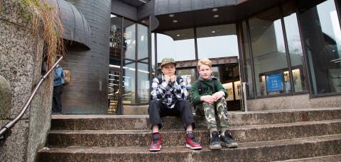 Two children sitting on the main library steps.