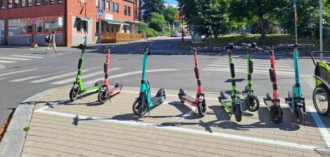 Electric scooters in the parking grid during the summer.