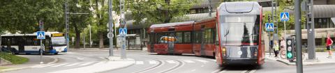 A red tram at the crossroads near the main library Metso.