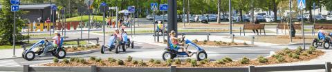 Children driving pedal cars in Children’s traffic park.