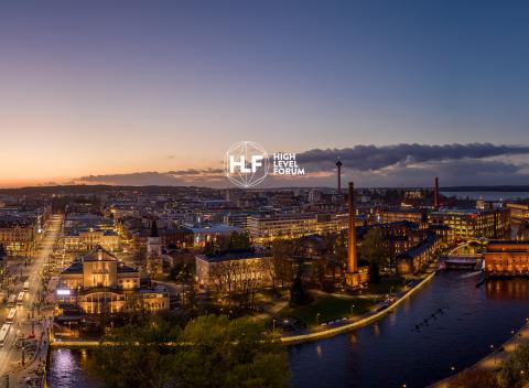 Tampere city center and sunset from air with High Level Forum logo 