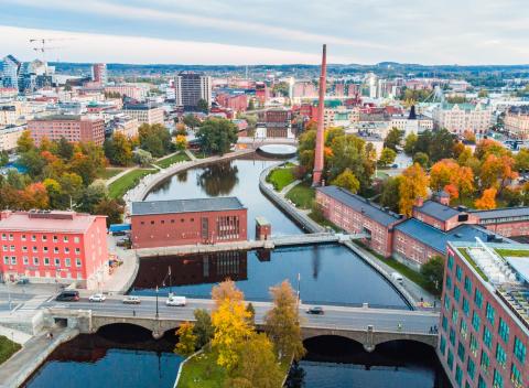 Tampereen keskustaa syysväreissä ilmasta kuvattuna, keskellä Tammerkoski ja etualalla Satakunnan silta sekä Patosilta.
