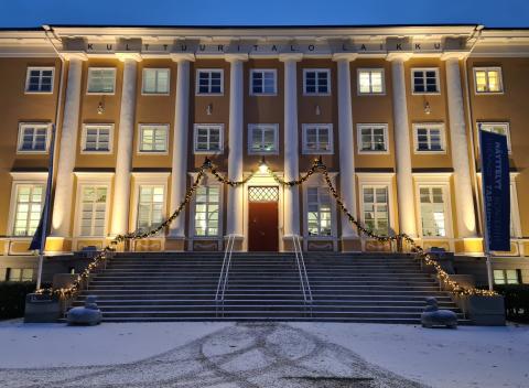 A large yellow building in dim winter lighting.