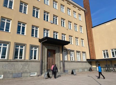 People entering through the main entrance of the Nekala Cultural Centre.