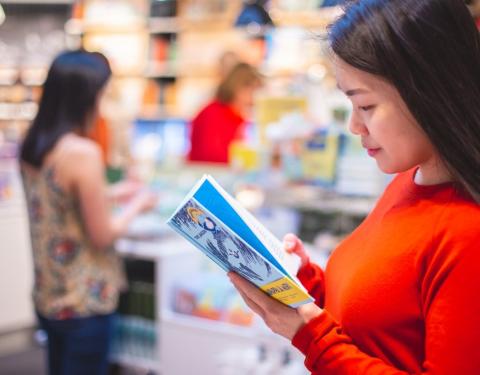 Woman looking at a brochure.