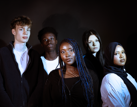 Five young people in a group photo.