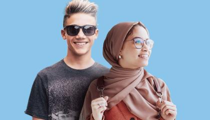 Kaksi nuorta henkilöä hymyilee kuvassa innostuneen näköisinä.