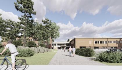 Havainnekuvassa matala koulurakennus.