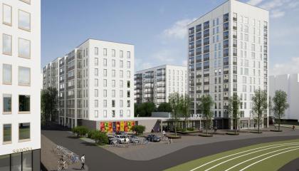 Kuvassa katu ja tori, raitiotie ja valkoisia kerrostaloja.