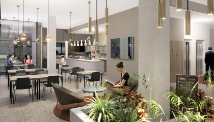 Havainnekuva kahvilan pöydistä ja etualalla olevasta kasvialtaasta, joka kiertää pylvästä.