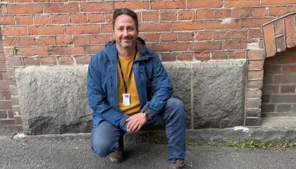 Klaus katsoo hymyillen suoraan kameraan polviseisonnassa.