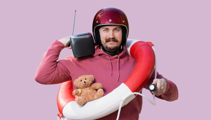 Partainen mies kypärä päässä, radio olallaan ja pelastusrengas kaulassaan.